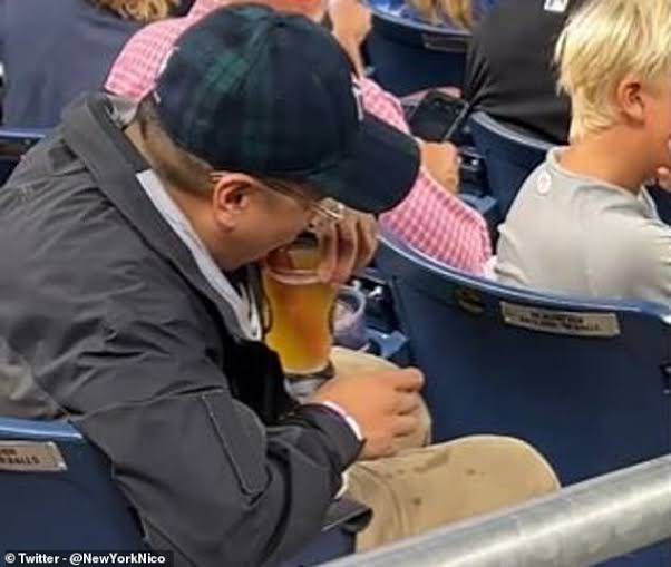 New York Yankees fan turns his hot dog into a...